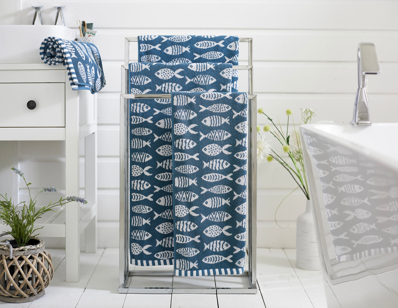 Small Fish cotton towels on a stand — ocean blue jacquard fish design