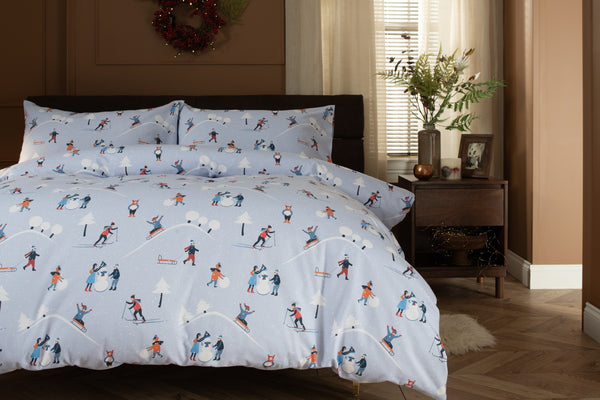 The Lyndon Company Fun Day brushed cotton duvet set with skiers and sledgers on pale blue
