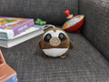 Cozytime Pressure Pal Sloth on a sofa