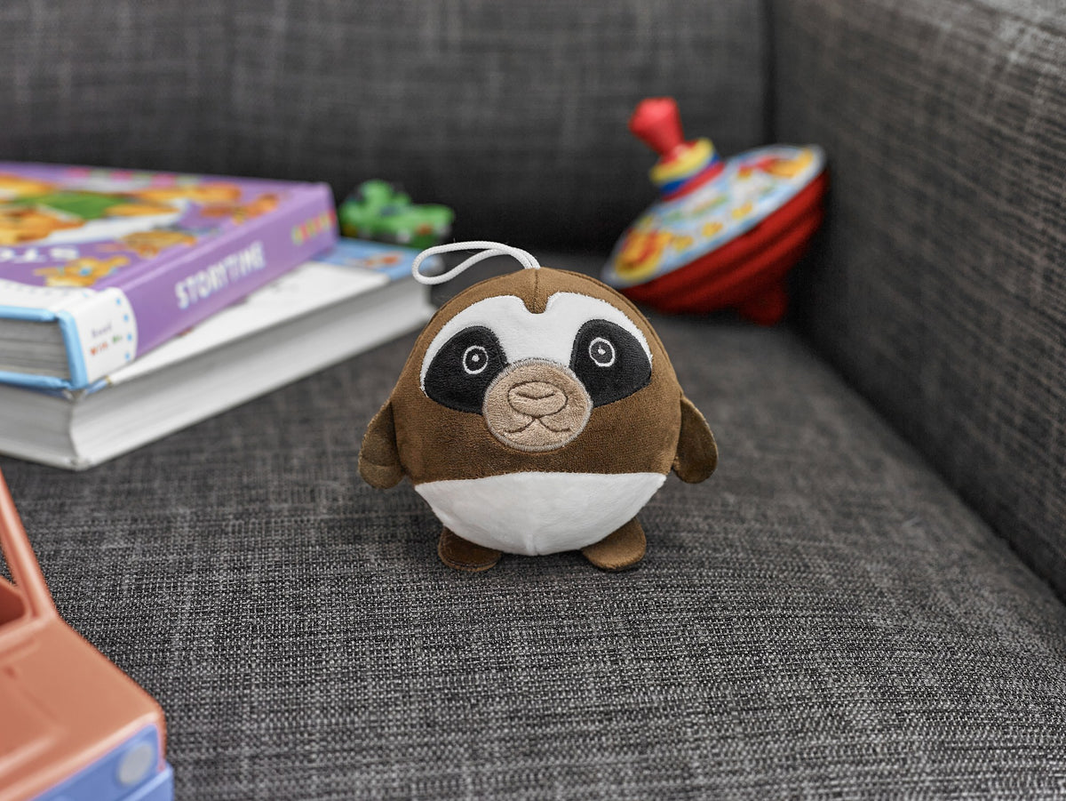 Cozytime Pressure Pal Sloth on a sofa
