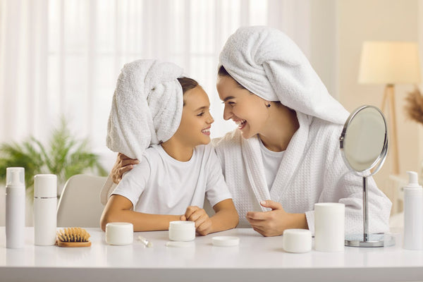 A mum and daughter in towel turbans laughing together